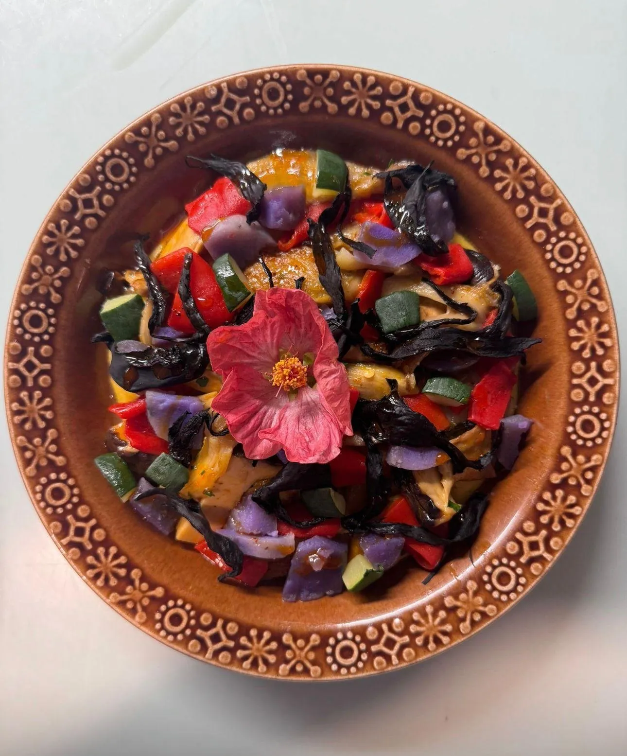 Flower-adorned plated dish on matcha dust